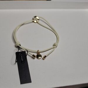 Marc by Marc Jacobs Cord Friendship Bracelet in Cream with a Gold-Tone Charm.